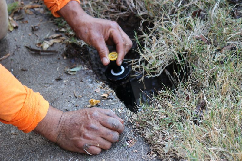 Technician Repairing Sprinkler
